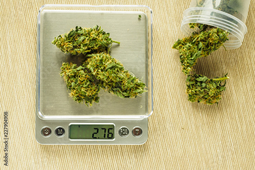 Cones of cannabis flowers on the scales. Measuring of Buds of medical marijuana. Weighing marijuana for sale. The legalization of soft drugs. Dealer sells drug bag. Black market of drugs trade.