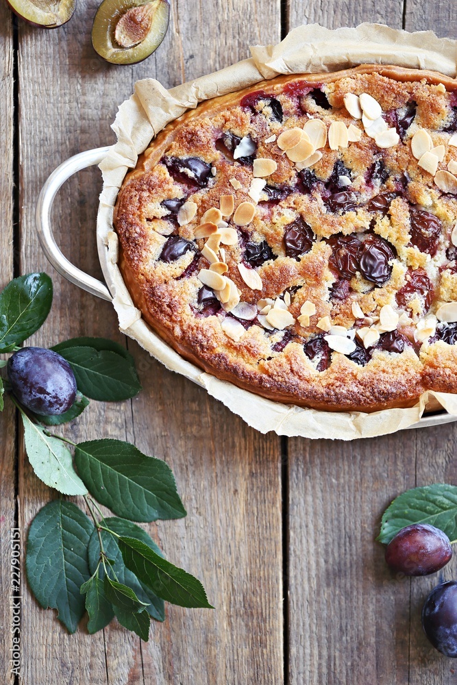Fototapeta premium Plum cake. Spicy cake with plums, almond filling and cinnamon. Overhead view