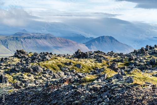 Lava field and a mountain range in western Iceland photo