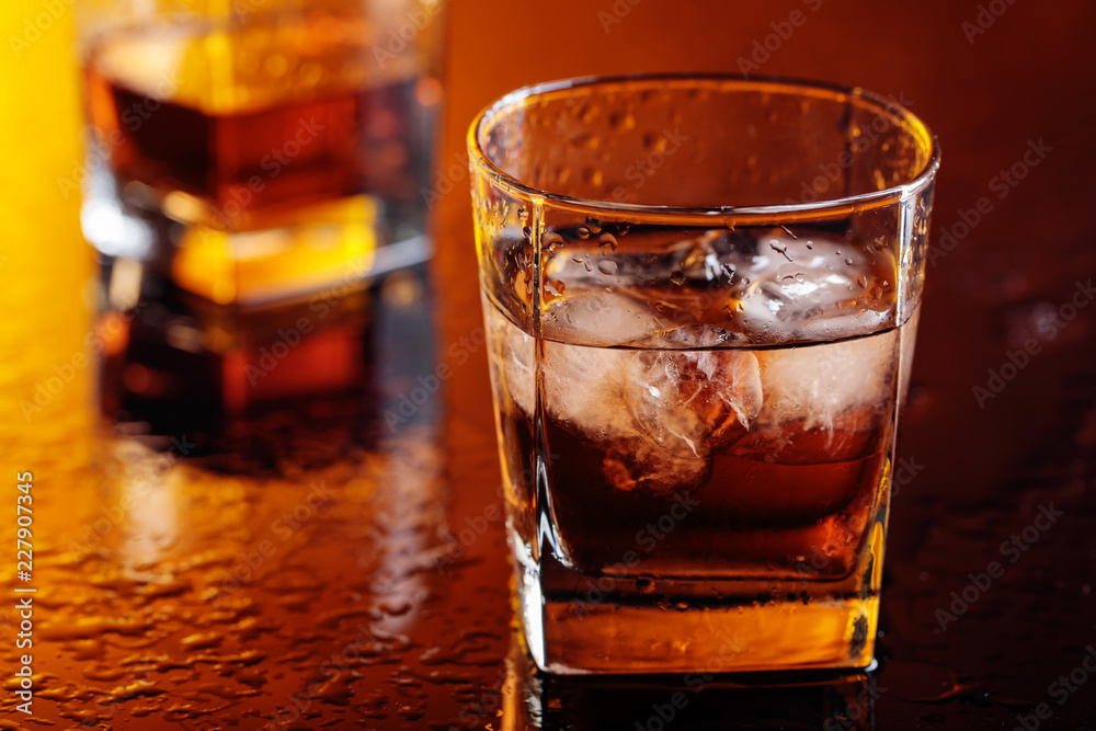 Glass of scotch whiskey with natural ice . Glass of scotch whiskey with natural ice .