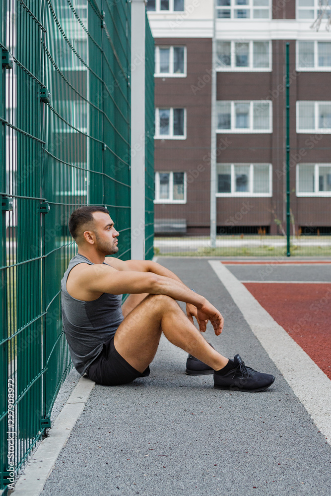 Athlete training in the open air. Workout on the playground. Athlete training in the open air. Workout on the playground.