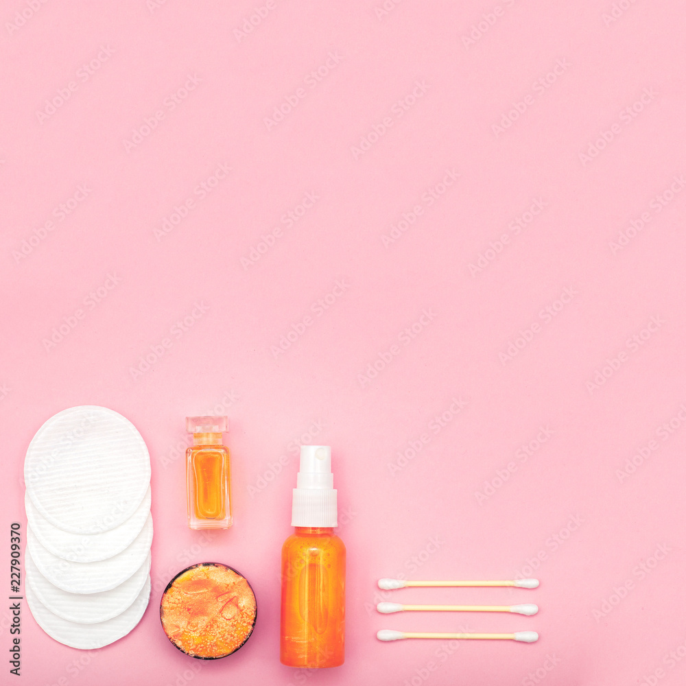 Gold cosmetic products on pink background Gold cosmetic products on pink background