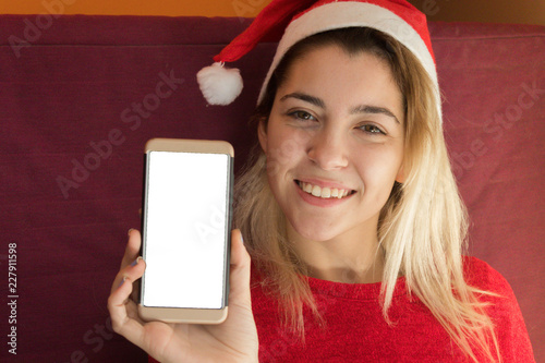 Woman showing a smartphone at Christmas photo