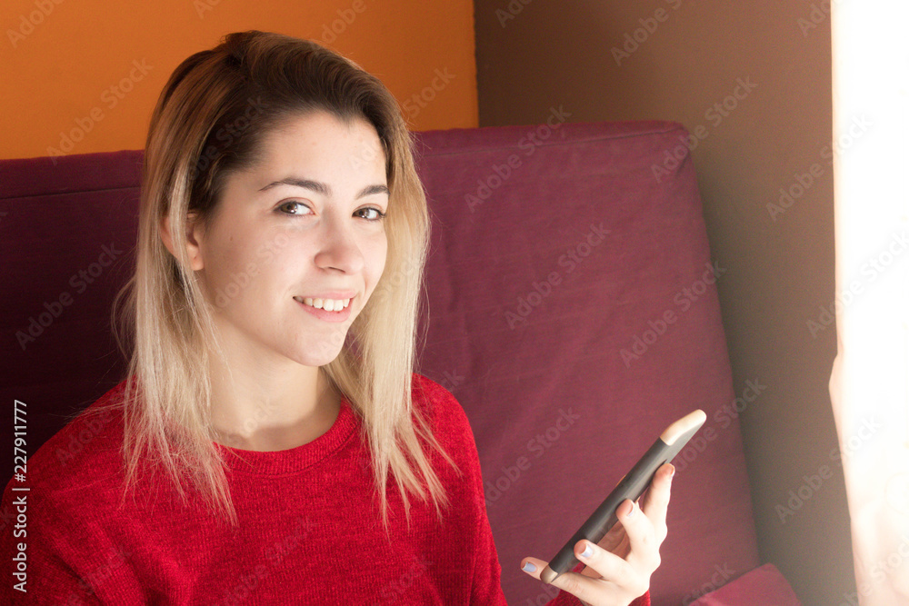 Woman talking on the phone at home in winter Woman talking on the phone at home in winter
