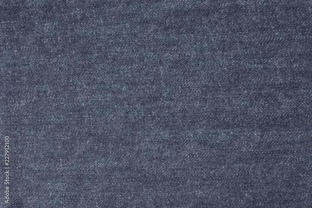Old blue denim jeans texture or background with visible fibers Old blue denim jeans texture or background with visible fibers