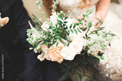 Beauty wedding bouquet with different flowers in hands