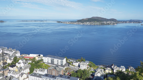 Panoramic north-west views of the town of Alesund, Norway, from partway up Aksla, a hill that overlooks the town and the surrounding fjord, in a morning summer day