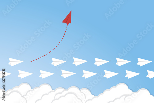 Think different. Think differently concept. Red airplane changing direction. New idea, change, trend, courage, creative solution, innovation and unique way concept.