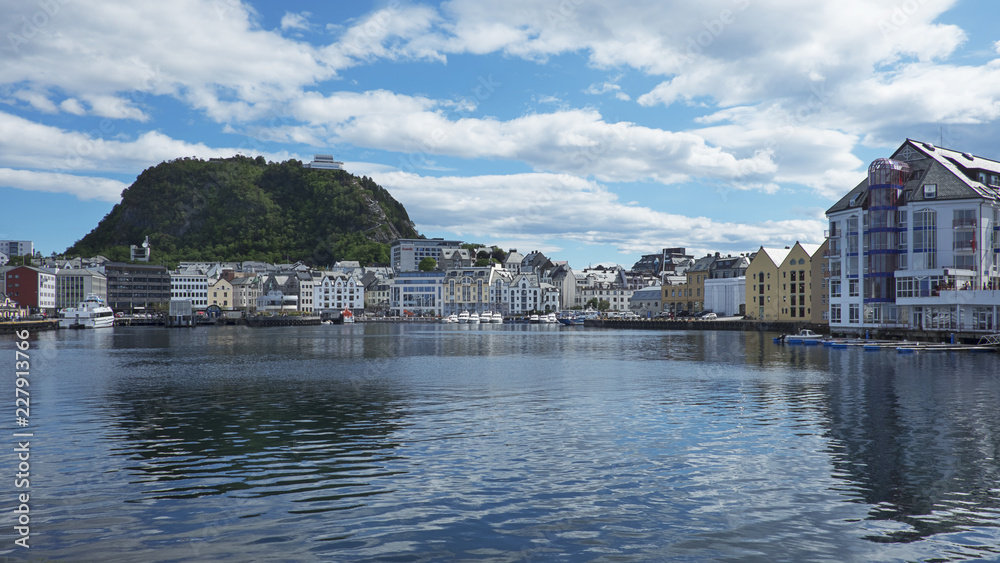 Panoramic views towards the town with its Art Nouveau architectural style buildings and Aksla hill in the background, from the close by pier at Fisheries Museum, Alesund, Norway