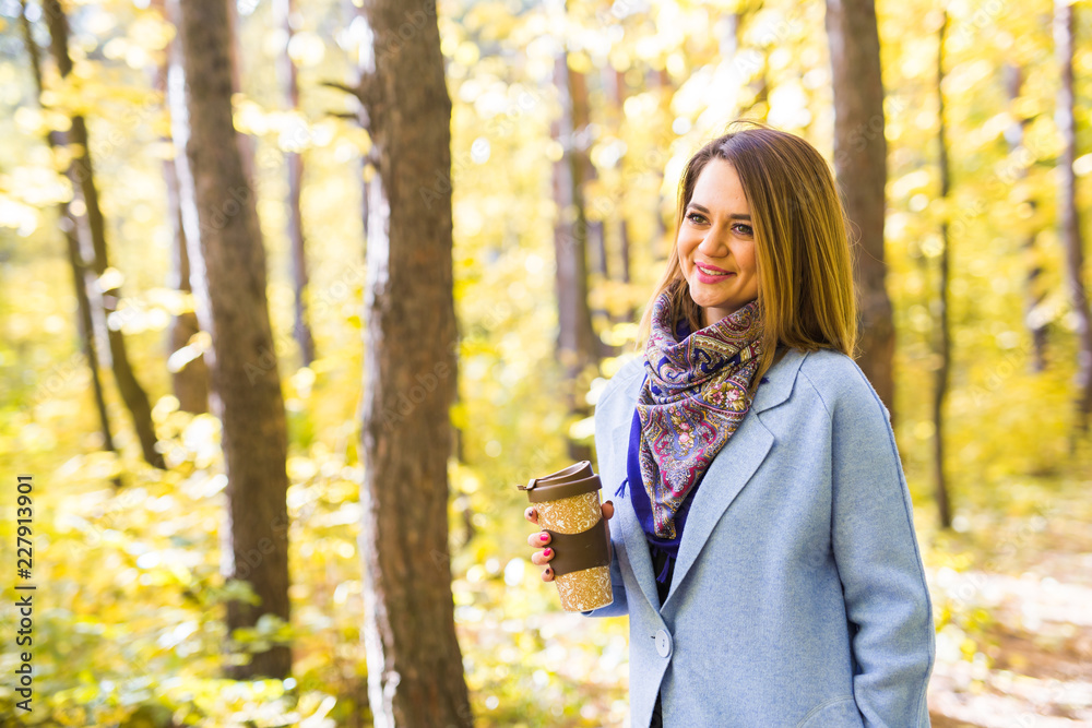 Autumn, drinks and people concept - Woman holding cup of hot drink Autumn, drinks and people concept - Woman holding cup of hot drink