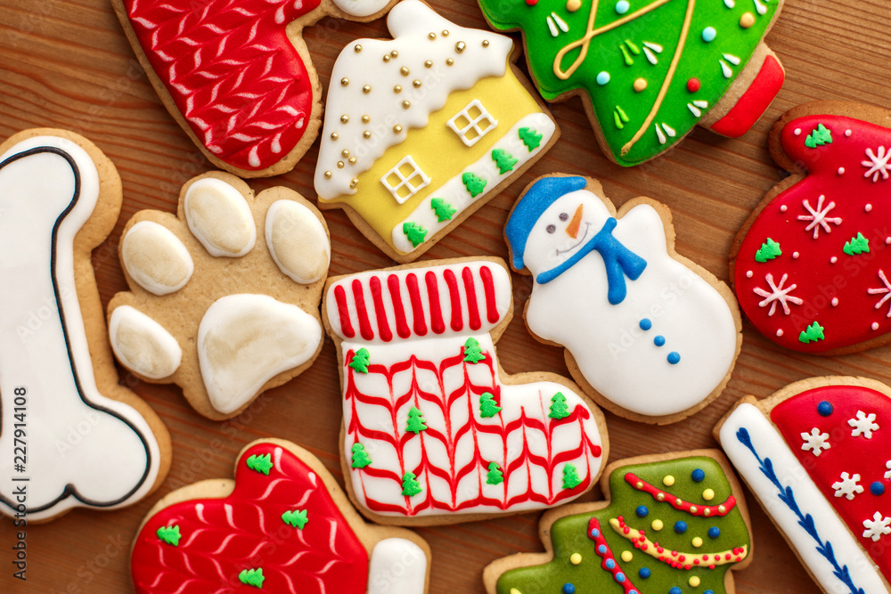 Colorful christmas cookies set lay on wooden table. Holidays food and decoration concept.