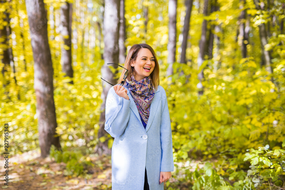 Nature, season and people concept - young woman laughing at the autumn park Nature, season and people concept - young woman laughing at the autumn park