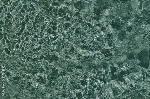 Close up. Bubbling water in the pool, blue texture of boiling water.