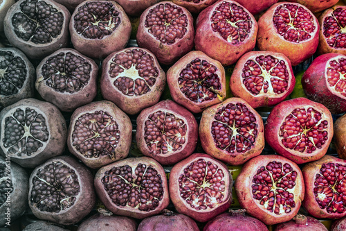Fototapeta Naklejka Na Ścianę i Meble -  Sliced pomegranates in front of a juice stand.