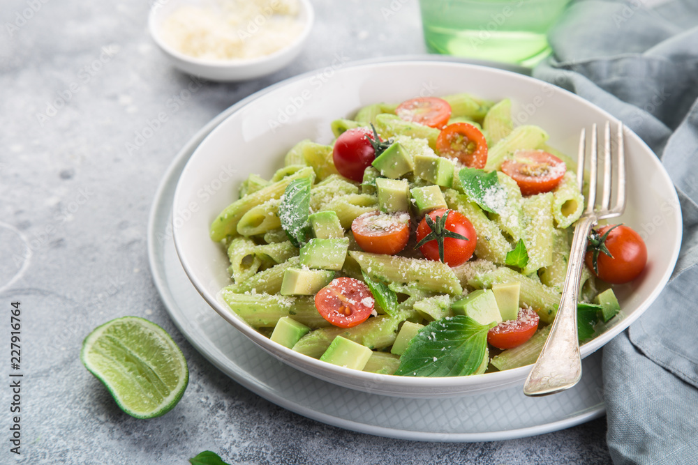 penne pasta with creamy avocado sauce and tomatoes