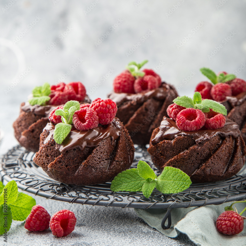 delicious chocolate muffins with chocolate topping and fresh raspberry delicious chocolate muffins with chocolate topping and fresh raspberry