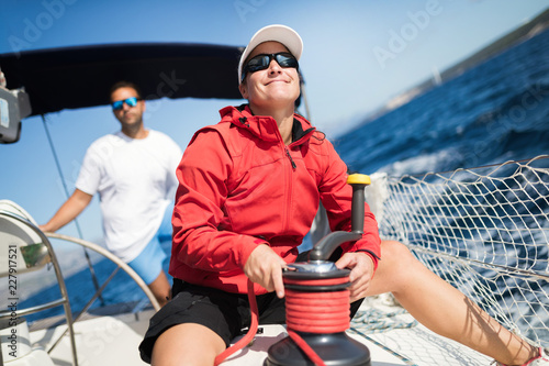 Attractive strong woman sailing with her boat photo