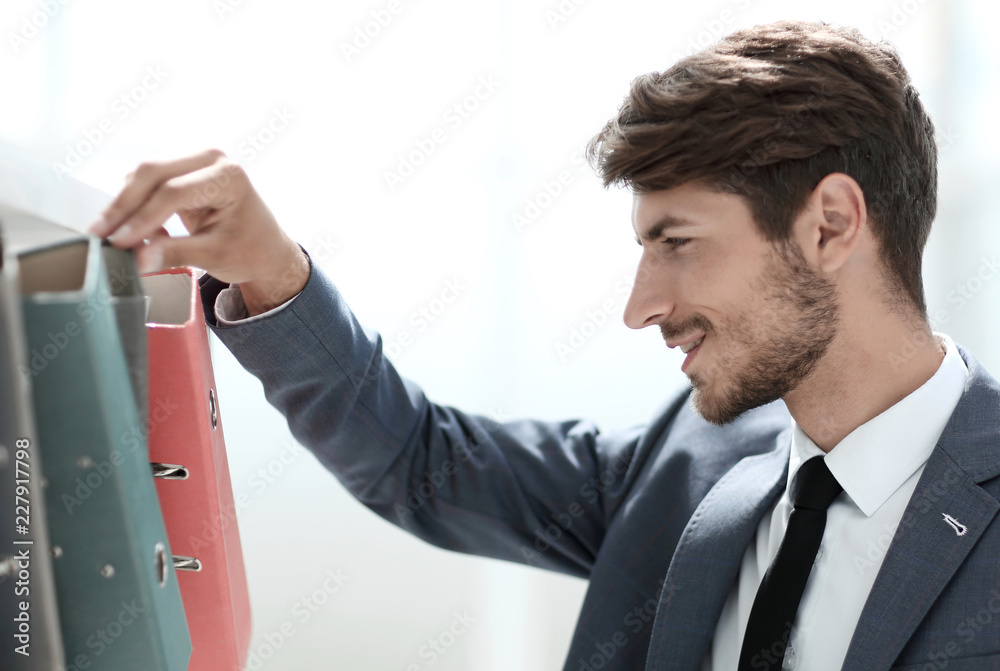 Young happy businessman look at documents Young happy businessman look at documents