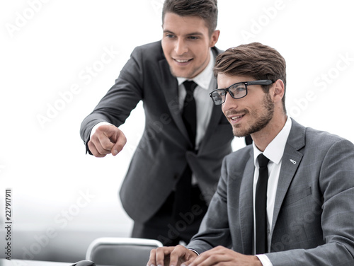 Successful adult man is looking at screen of modern gadget