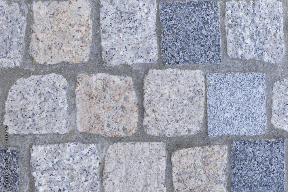 Fototapeta premium background of beige dark tery and light granite square paving stones and tiles