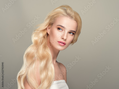 Beautiful blonde girl portrait, woman face with perfect long hairstyle.