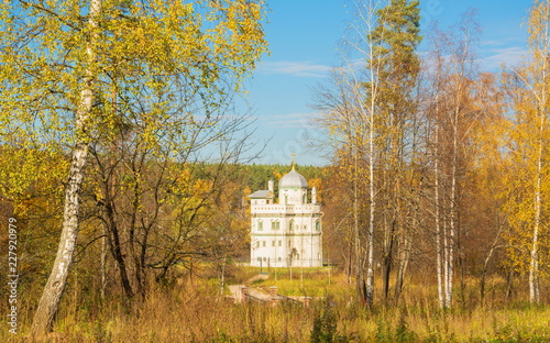 Little white church in the autumn forest