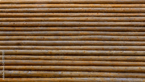 Log wall. Background of wooden logs. Wood texture.