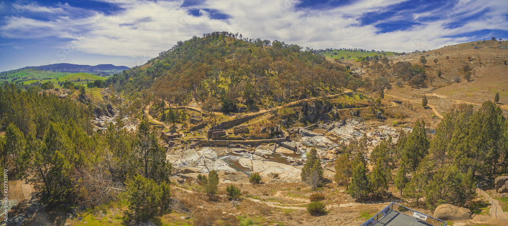 Adelong falls and gold mill ruins on bright sunny day, NSW, Australia - aerial panorama