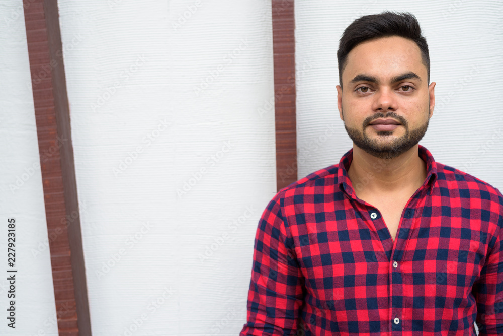 © Ranta Images - Young bearded Indian businessman relaxing at the mall in Bangkok