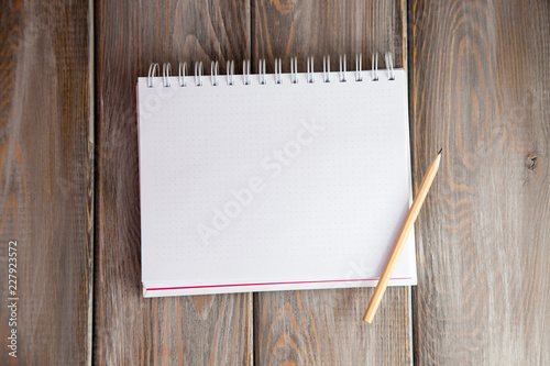 notebook on a wood background. Layout for inserting text and image