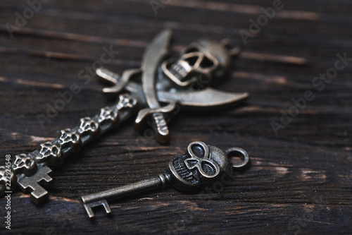 Vintage skull skeleton keys on a wooden table photo