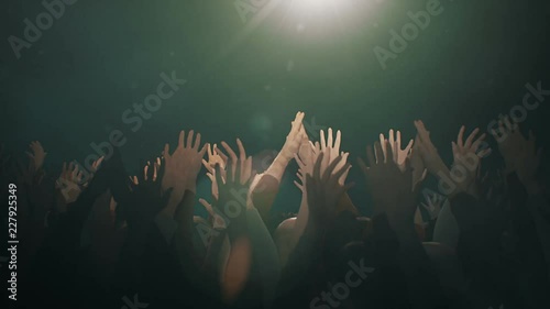 Hands raised in worship with lens flare and white Dove. photo