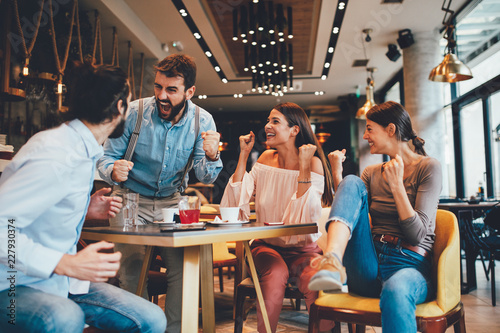 Group of friends watching game in cafe