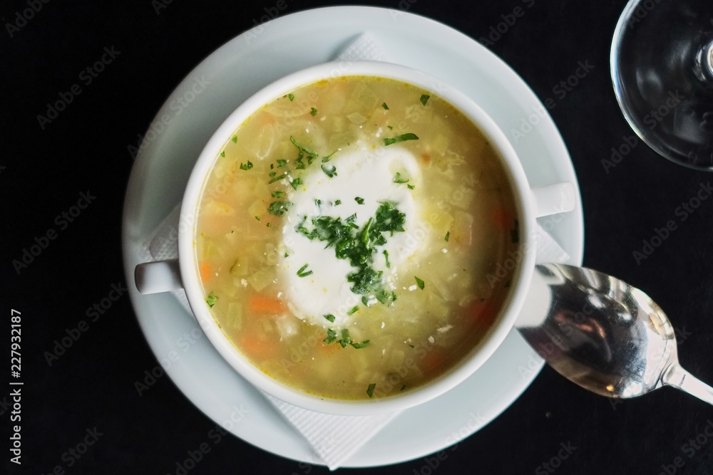 Bowl with soup served with glass .Delicious business lunch menu in cafe.