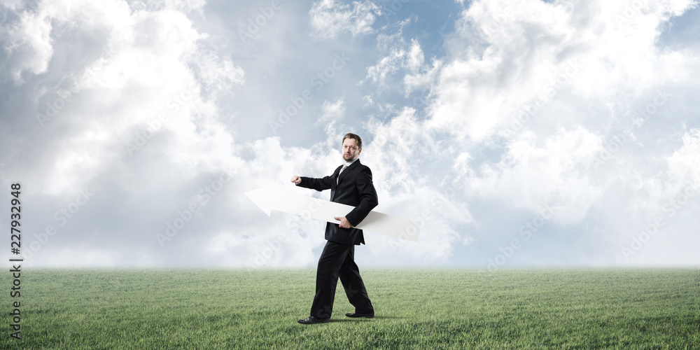 Conceptual image of businessman pointing aside