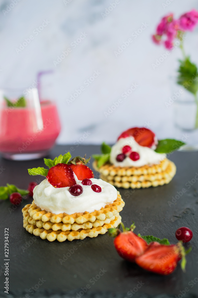 Waffles with whipped cream and strawberries Waffles with whipped cream and strawberries