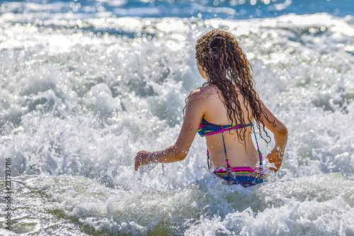 girl on the beach having a splash