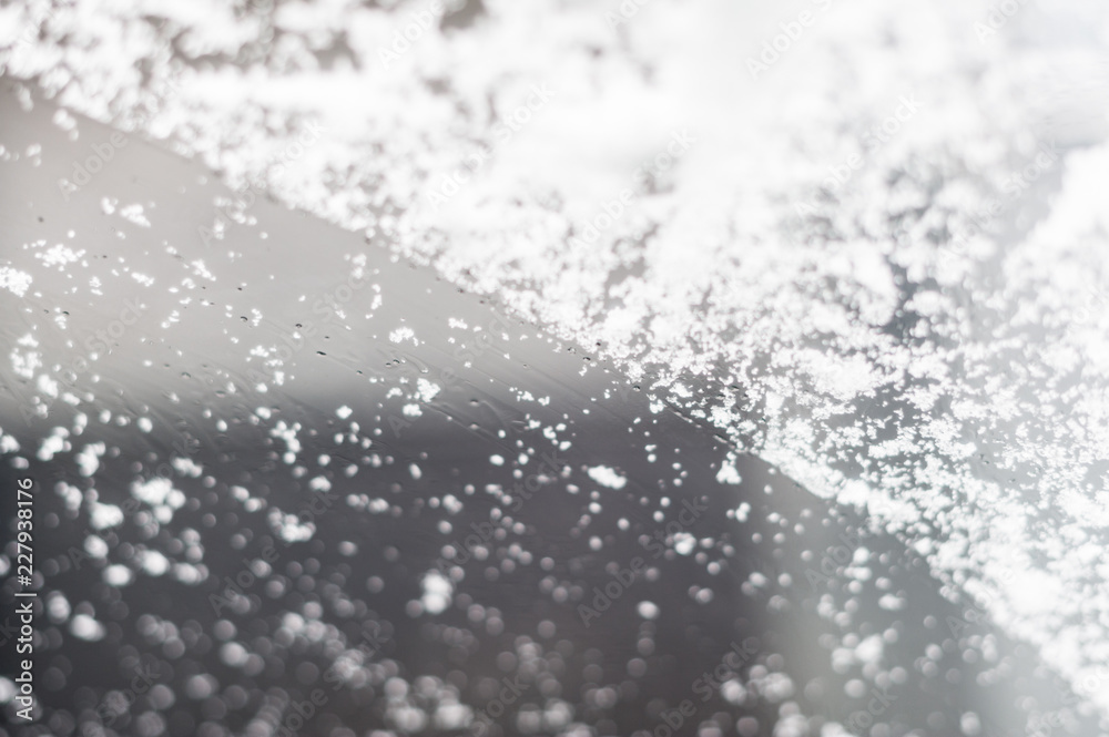 Snow on a car's front windshield selective focus Snow on a car's front windshield selective focus