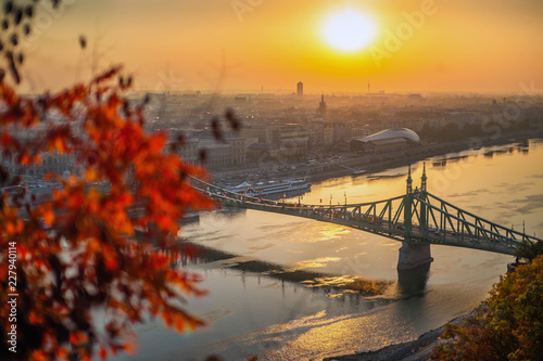 Budapest, Hungary - Autumn foliage with Elisabeth Bridge at sunrise. Traditional yellow tram on the bridge