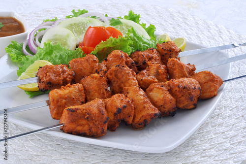 Chicken Boti Kebab, Delicious spicy and marinated boneless chicken meat cooked on charcoal flame. photo