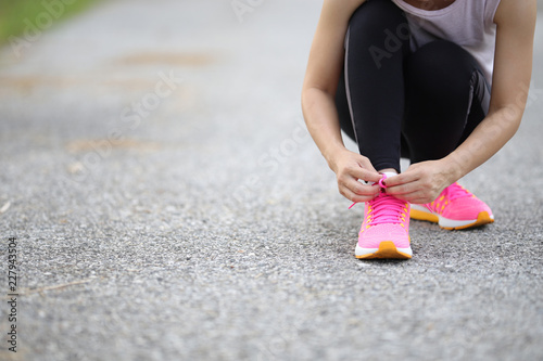 Woman exercising tie shoes.