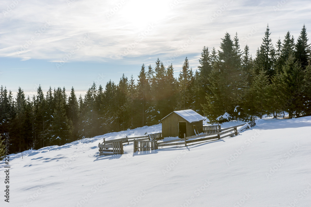 Weathered wooden shepherd hut on the mountain in winter