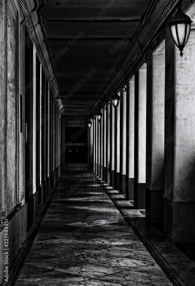 Corridor with columns in black and white selenium photo, abstract architectural photo, black and white photo, columns, diagonal, street photography. Architectural details. Malta