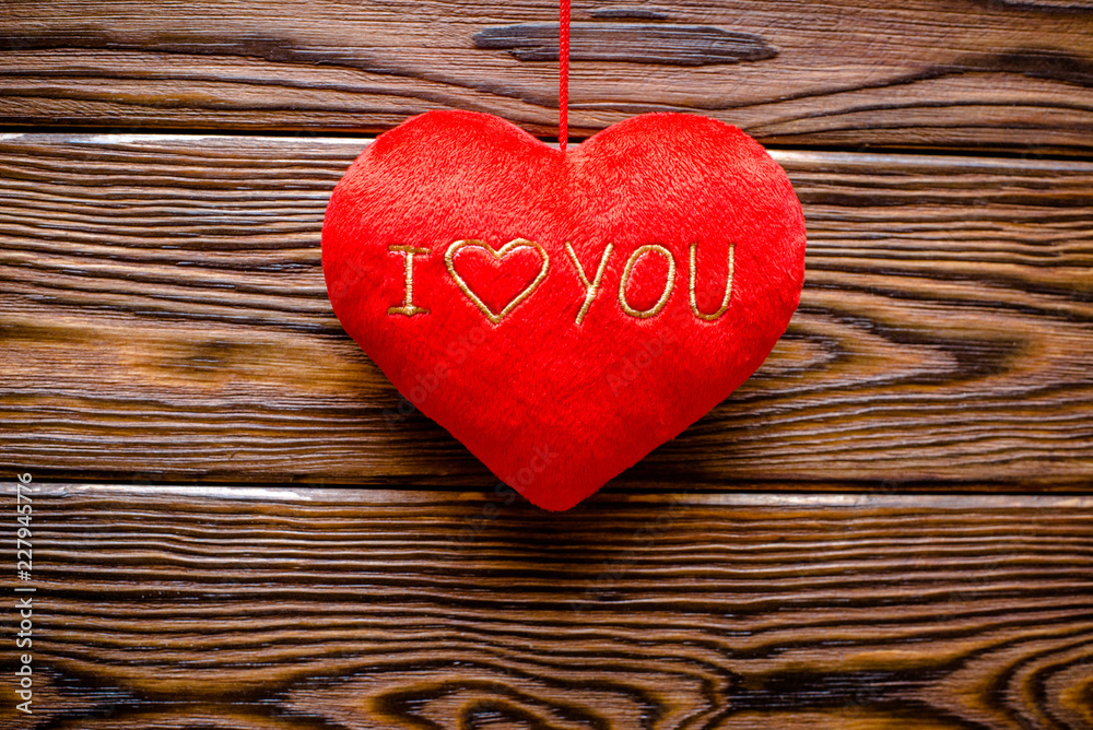 Fototapeta premium A symbol of love on brown background derevier 