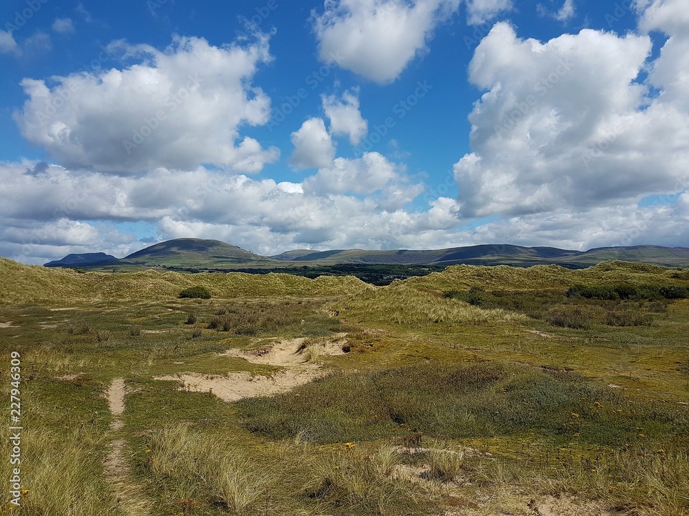 Landscape scene across the sand dunes of Talybont beach in North Wales on a summer day. Landscape scene across the sand dunes of Talybont beach in North Wales on a summer day.