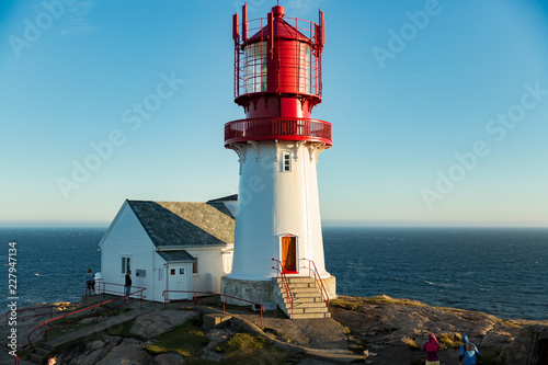 Old Lighthouse Lindesnes fyr is a coastal lighthouse located on the southernmost point of continental Norway in Lindesnes, South Cape. Serene Scandinavian landscape, Rocky Mountains, fjord, sunset sky photo