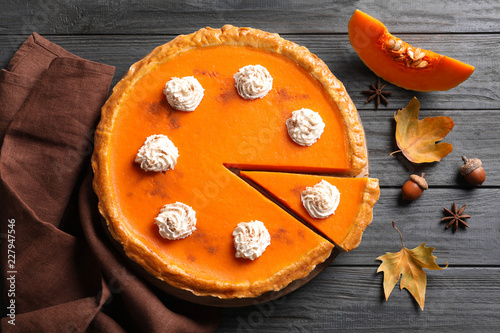 Canvastavla Fresh delicious homemade pumpkin pie with whipped cream on wooden background, fl