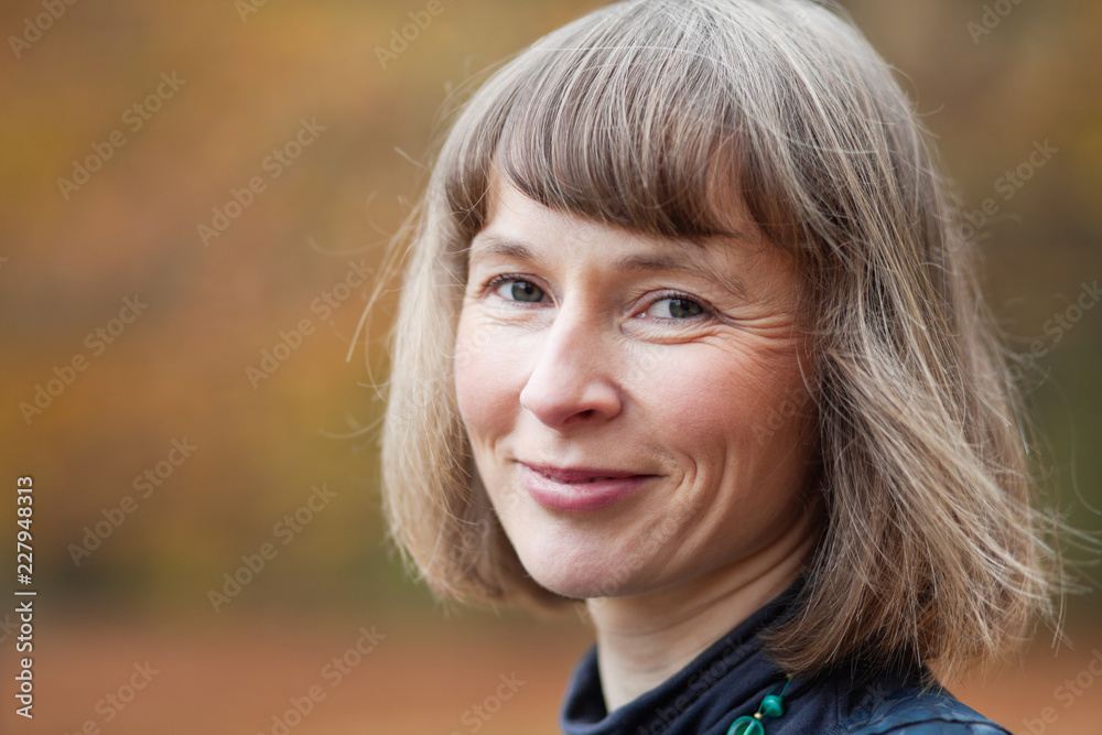 Outdoor portrait of smiling middle aged woman