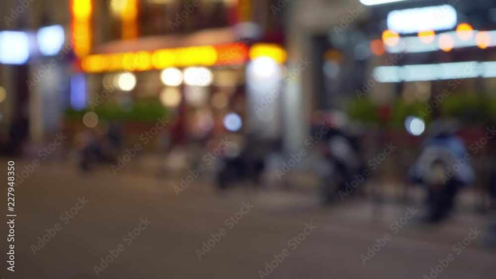 Bokeh night scene of motorcycle parked in front of shops Bokeh night scene of motorcycle parked in front of shops