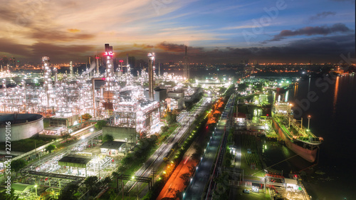 Oil refinery factory at dusk with beautiful sky for energy or gas industry background.